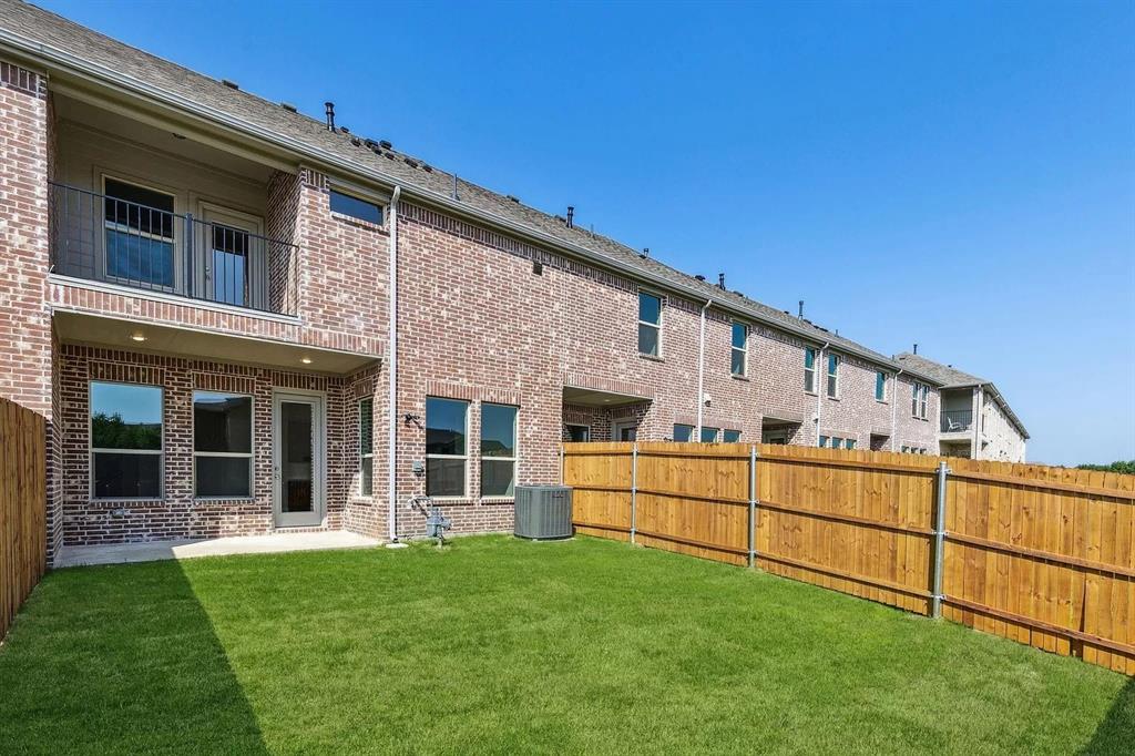 1752 Redding Street Allen, TX 75002 - Photo 22 of 24 Rear view of property featuring a balcony, a lawn, and cooling unit