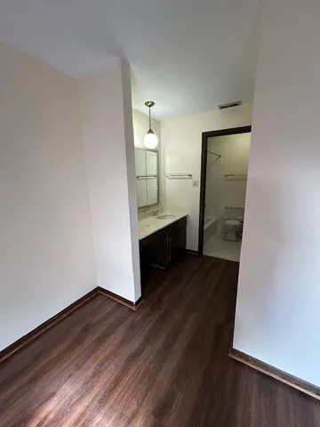 wooden floor in an empty room with a mirror