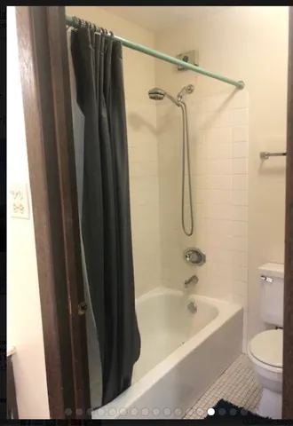 a bathroom with a shower curtain and a sink