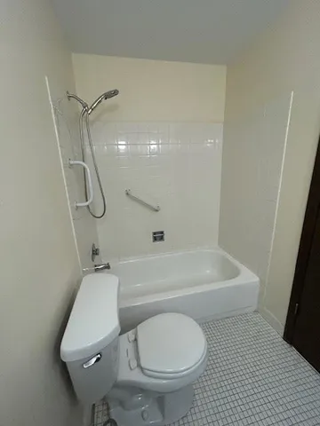 a bathroom with a toilet and a bath tub