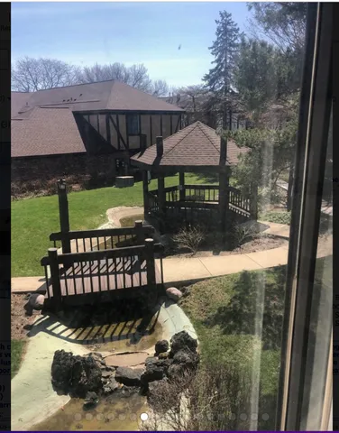 a view of a deck with a table and chairs under an umbrella