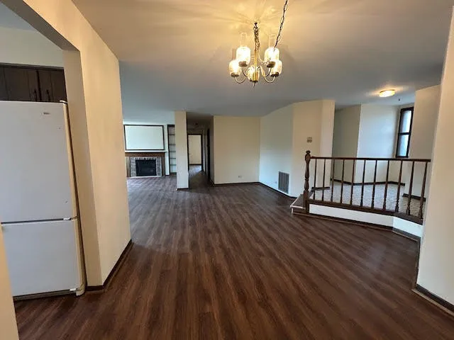 a view of a room with wooden floor and staircase