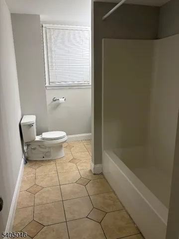 a kitchen with granite countertop a stove top oven a sink dishwasher and a refrigerator with wooden floor