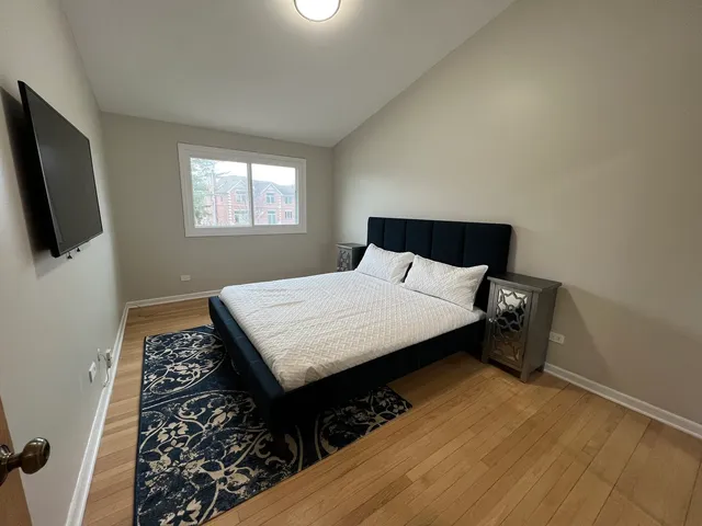 a bedroom with a bed and flat screen tv