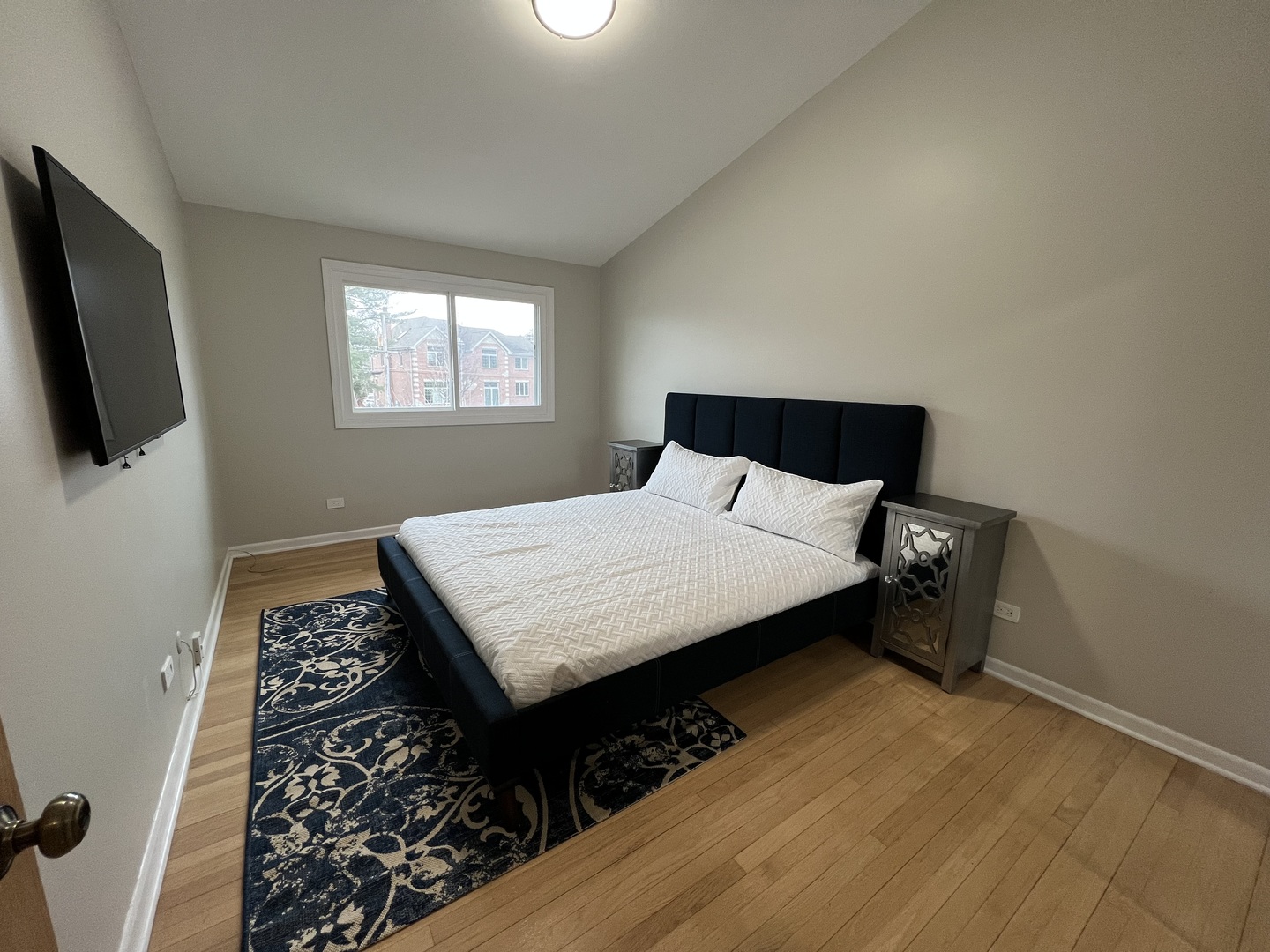 725 Hibbard Road Wilmette, IL 60091 - Photo 12 of 15 a bedroom with a bed and flat screen tv