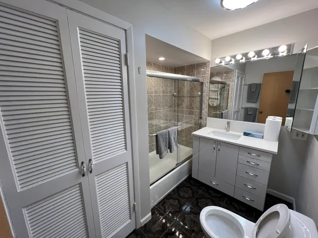 a bathroom with a toilet sink and mirror