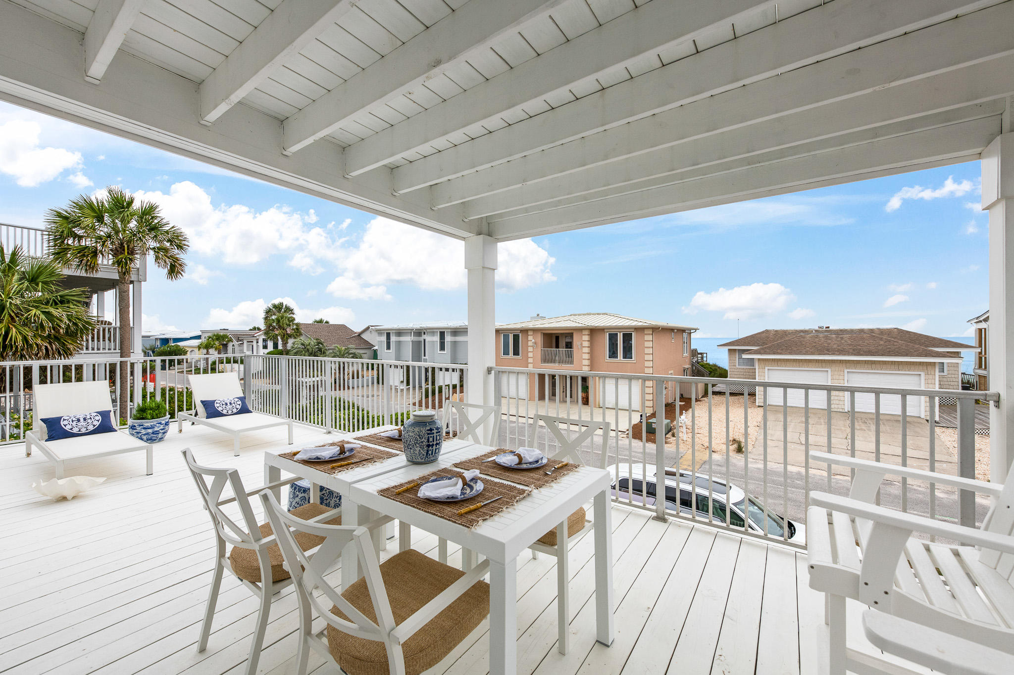 207 Sand Cliffs Drive Inlet Beach, FL 32461 - Photo 17 of 26 a view of a patio with couches table and chairs and potted plants