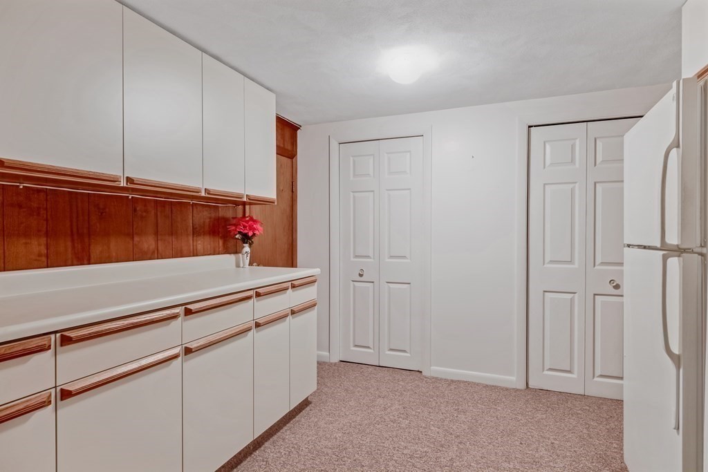 7 Bowser Road Lexington, MA 02420 - Photo 34 of 39 a view of a kitchen with white cabinets