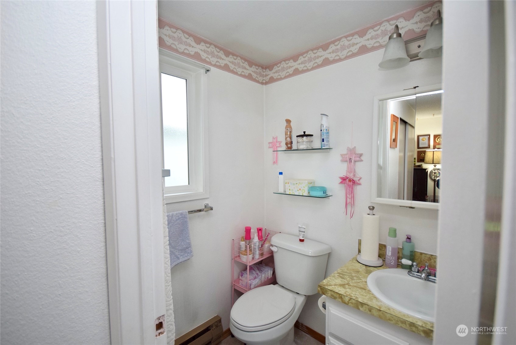 52 Juniper Mobile Estate Sequim, WA 98382 - Photo 17 of 21 a white toilet sitting next to a bathroom sink and vanity