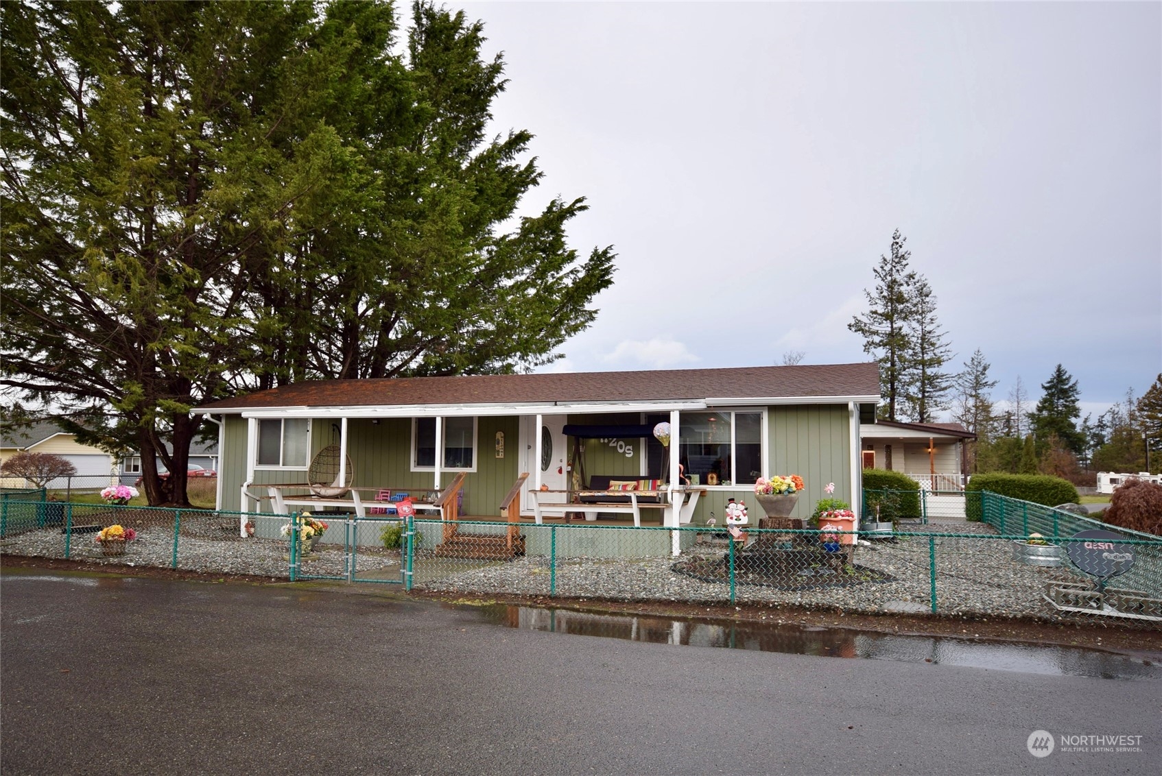 52 Juniper Mobile Estate Sequim, WA 98382 - Photo 2 of 21 a view of a house with a patio