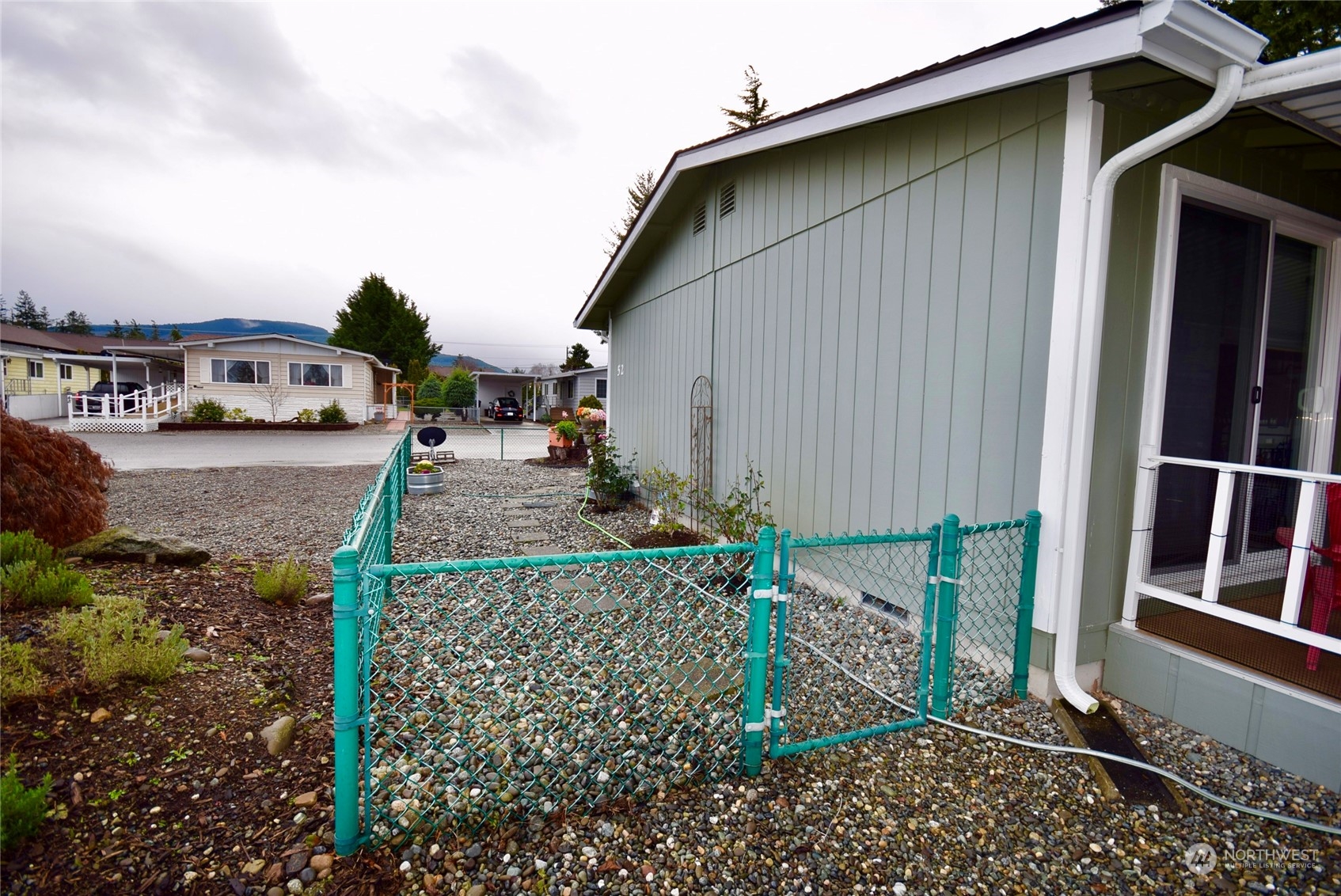 52 Juniper Mobile Estate Sequim, WA 98382 - Photo 21 of 21 a front view of a house with garden
