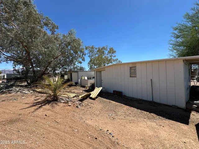 a backyard of a house with table and chairs