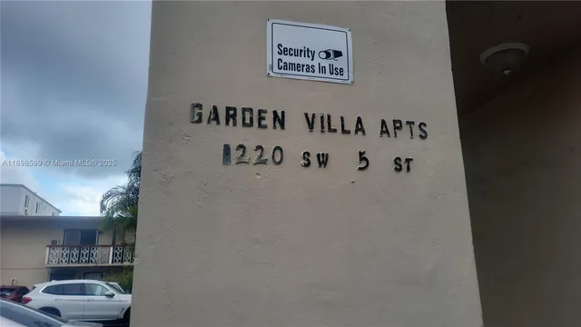 a white wall with cabinet and a picture of door