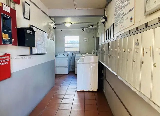 a utility room with cabinets washer and dryer