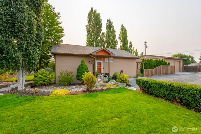 a front view of house with yard and green space