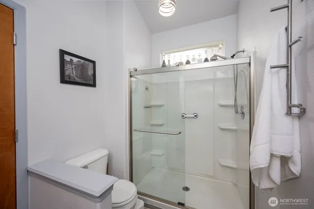 a bathroom with a shower a toilet and sink