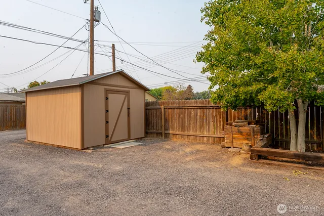 a view of backyard with wooden fence
