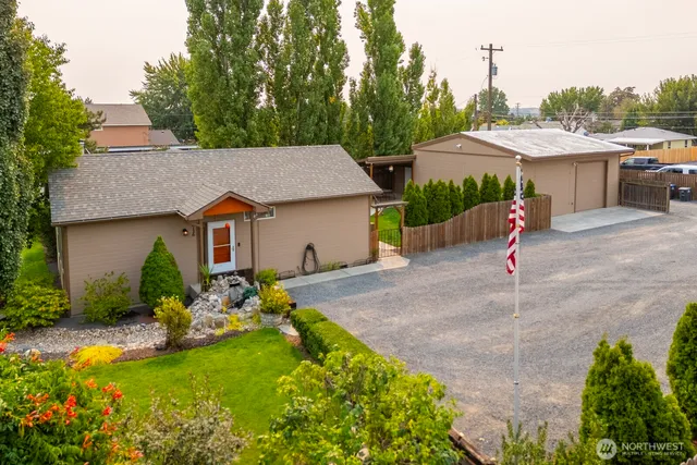 a aerial view of a house with swimming pool and a yard
