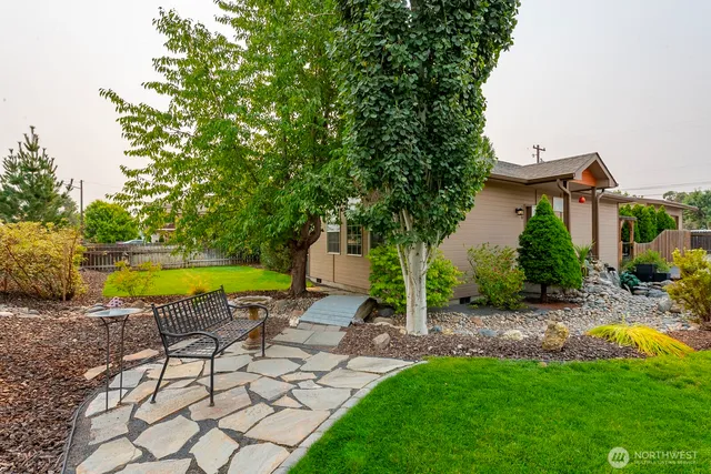 a view of a swimming pool with a lounge chair and a yard