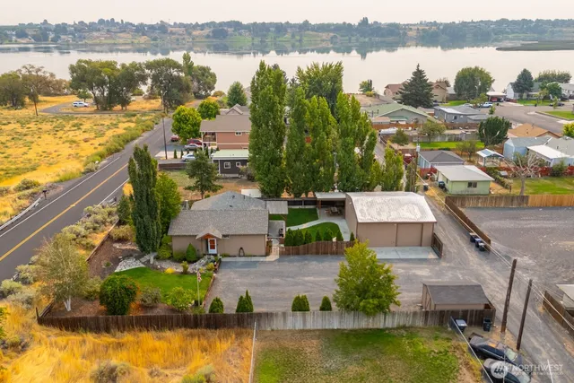 an aerial view of residential houses with outdoor space and lake view