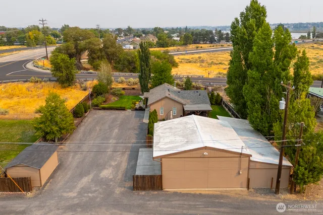 an aerial view of residential houses with outdoor space and ocean view