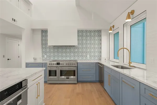 a kitchen with stainless steel appliances granite countertop a sink stove and oven