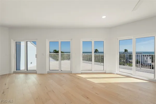 a view of a room with wooden floor and windows
