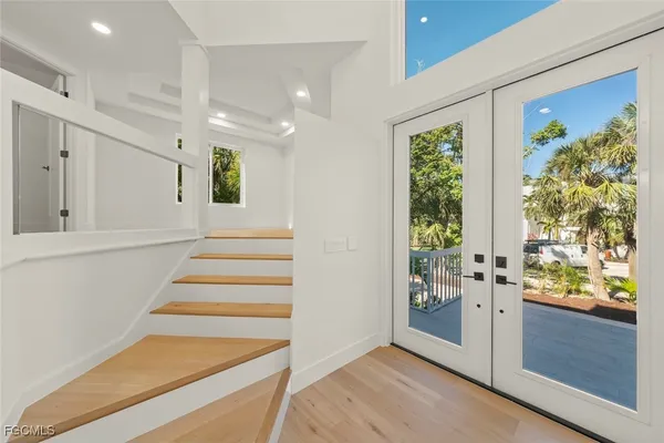 a view of an entryway with wooden floor and windows