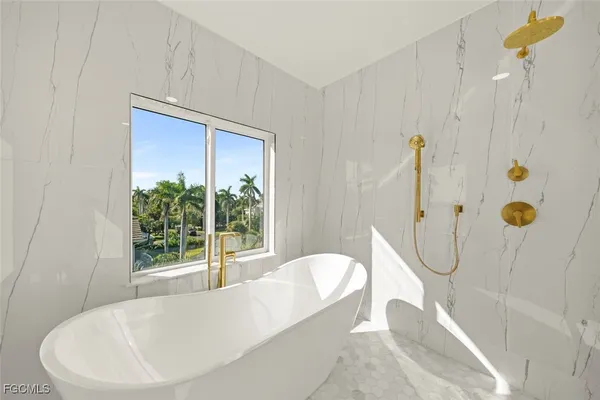 a bathroom with a bathtub and shower