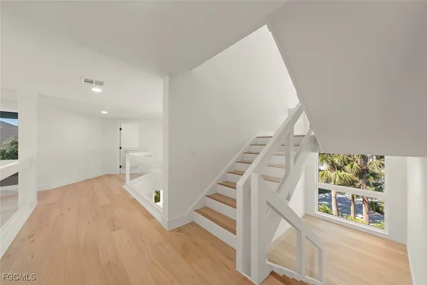 a view of an entryway with wooden floor and stairs