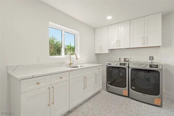a kitchen with white cabinets and white appliances