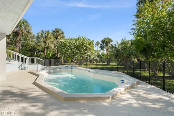a view of a swimming pool with a yard