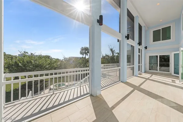 a view of a balcony with wooden floor and fence
