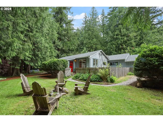 a view of a house with a yard and sitting area