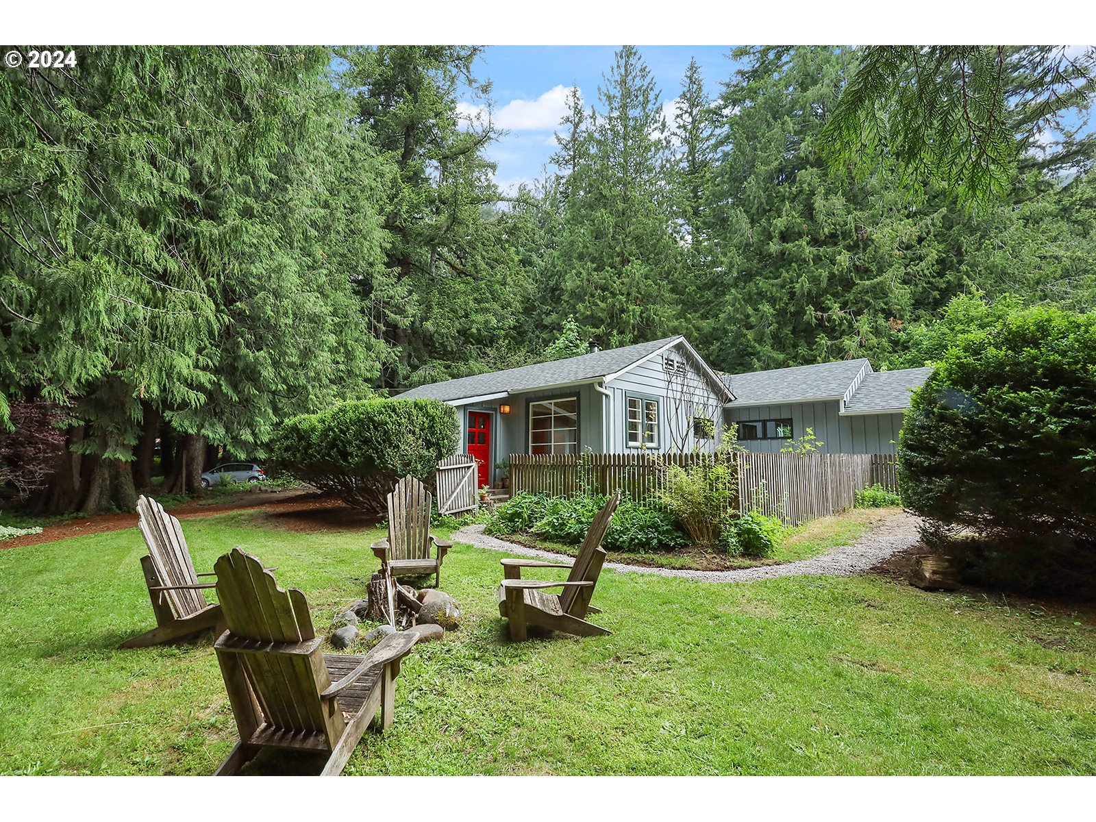 a view of a house with a yard and sitting area