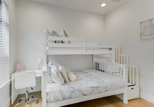 a bedroom with a bed and a table