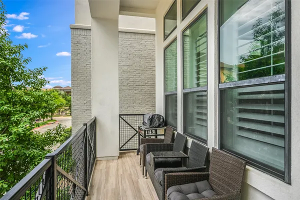 a view of balcony with wooden floor and outdoor seating