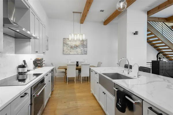 a kitchen with lots of counter space and wooden floor