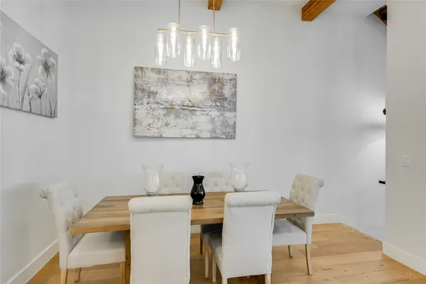 a dining room with furniture and wooden floor