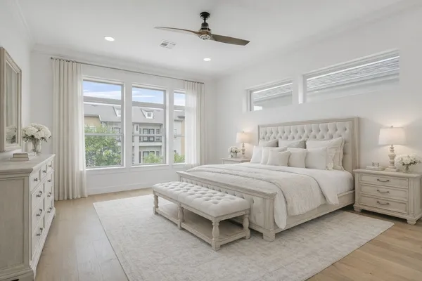 a spacious bedroom with a large bed and a chandelier