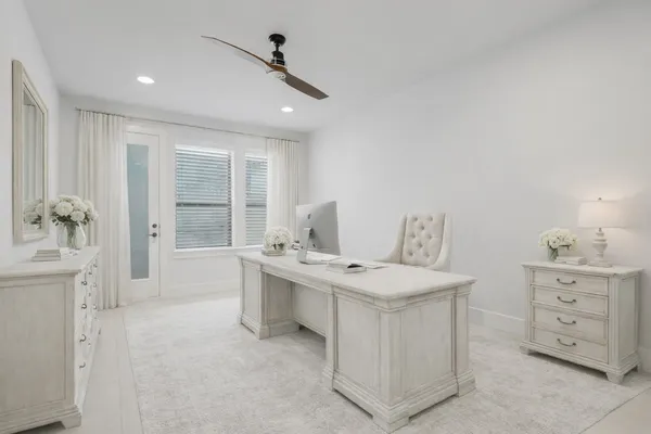 a living room with furniture a sink a window and a potted plant