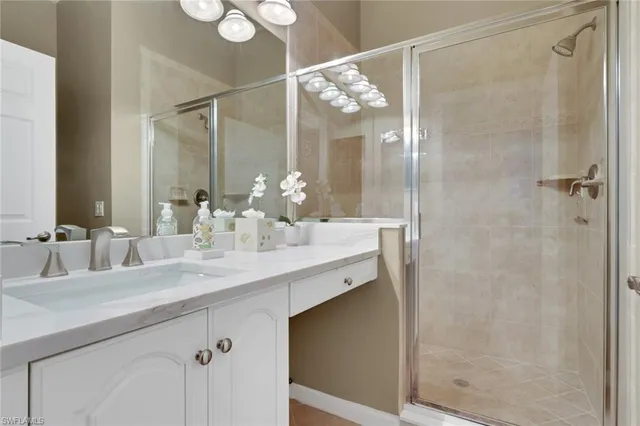 a bathroom with a double vanity sink mirror and shower