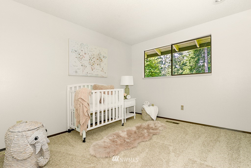 14413 157th Place Southeast Renton, WA 98059 - Photo 15 of 29 a view of a room with baby crib and a window