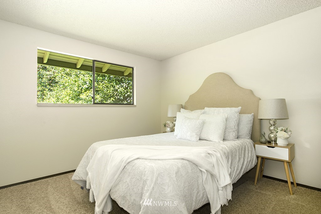 14413 157th Place Southeast Renton, WA 98059 - Photo 17 of 29 a bed sitting in a bedroom next to a window