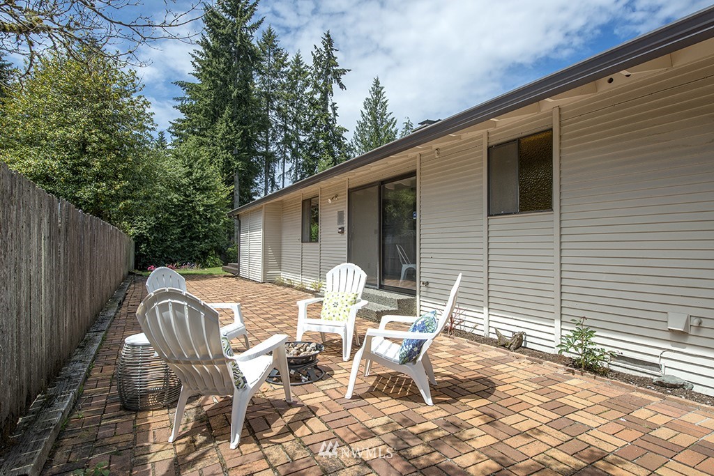 14413 157th Place Southeast Renton, WA 98059 - Photo 25 of 29 a view of a patio with table and chairs and wooden fence