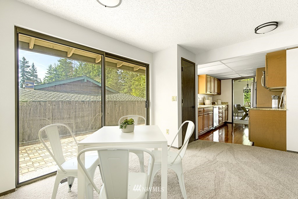 14413 157th Place Southeast Renton, WA 98059 - Photo 7 of 29 a view of a dining room with furniture a chandelier and wooden floor