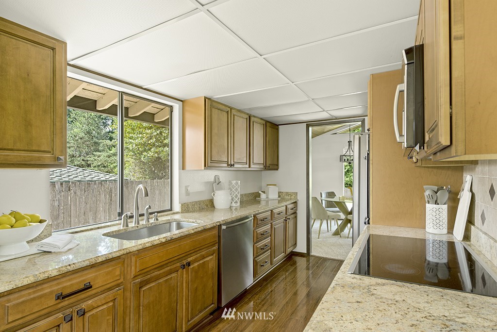 14413 157th Place Southeast Renton, WA 98059 - Photo 8 of 29 a kitchen with stainless steel appliances granite countertop sink stove and refrigerator