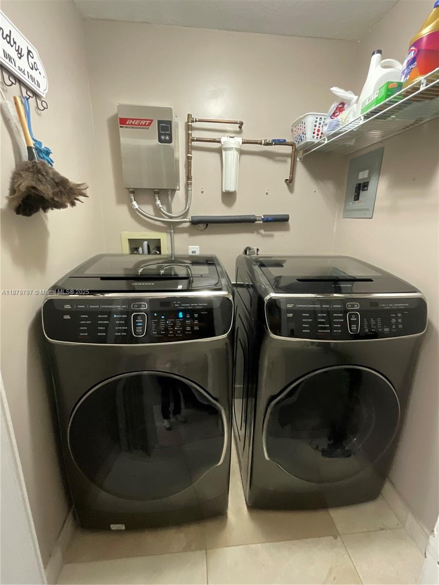 9710 Southwest 13th Street, Unit 9710 Pembroke Pines, FL 33025 - Photo 11 of 43 a close up view of washer and dryer