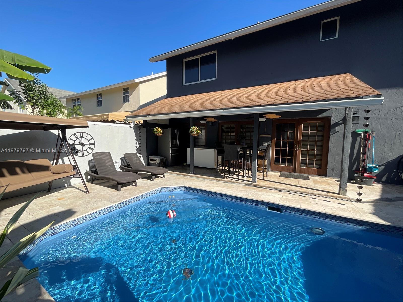 9710 Southwest 13th Street, Unit 9710 Pembroke Pines, FL 33025 - Photo 12 of 43 a view of swimming pool with patio