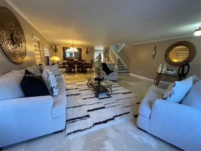 a living room with furniture and a mirror